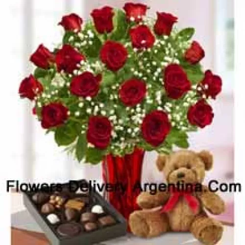 25 Red Roses With Some Ferns In A Glass Vase, A Cute Brown Teddy Bear And An Imported Box Of Chocolates