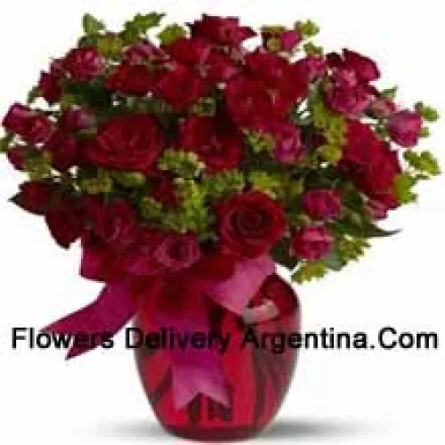 25 Red And 25 Pink Roses With Some Ferns In A Glass Vase