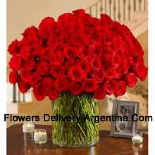 101 Red Roses With Some Ferns In A Big Glass Vase