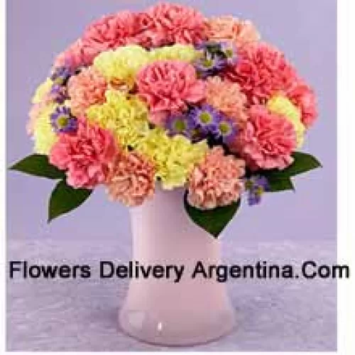 24 Mixed Colored Carnations With Seasonal Fillers In A Glass Vase