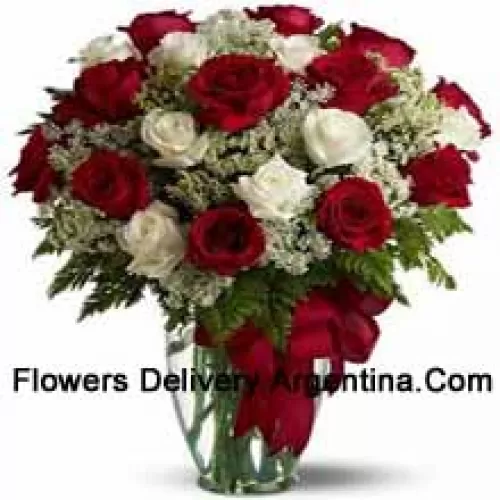 12 Red And 12 White Roses With Some Ferns In A Glass Vase