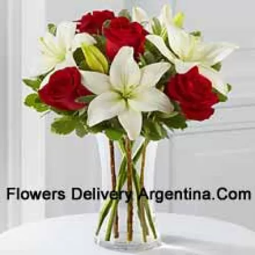 Red Roses And White Lilies With Some Seasonal Fillers In A Glass Vase